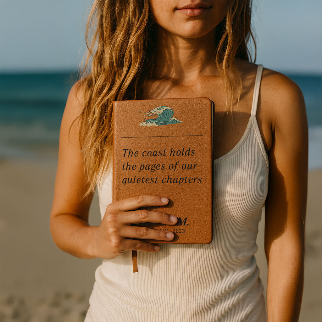 Person holding a brown notebook with text on a beach