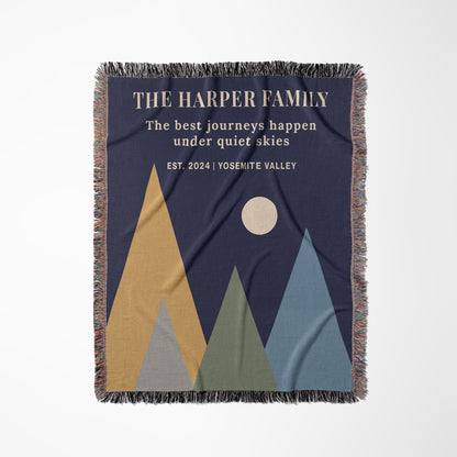 Blanket with mountain design and text 'The Harper Family' on a blue background