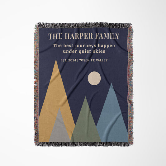 Blanket with mountain design and text 'The Harper Family' on a blue background